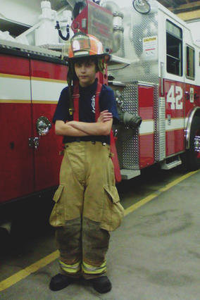 Ezra dressed in his junior volunteer firefighter gear. 