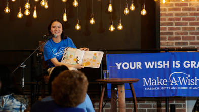 Wish kid Amelia on stage at her book launch party