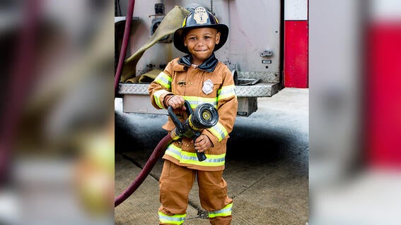 firefighter fighting fire with hose