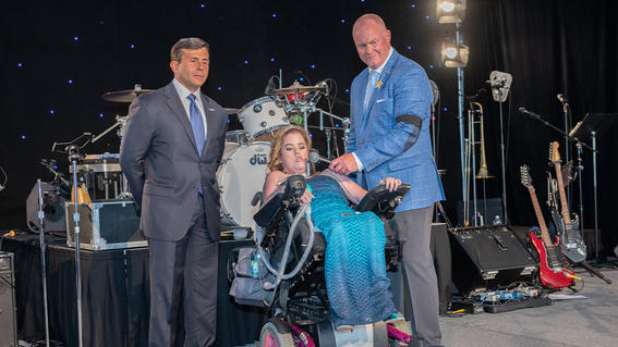 Megan Crowley, diagnosed with Pompe Disease, whose wish was granted in 2001 to go to Walt Disney World, gives an inspiring speech alongside her father, John Crowley, Chairman of the Board & CEO of Amicus Therapeutics and Chairman of the Board for Make-A-Wish America 2014-2016, with Make-A-Wish New Jersey President & CEO Tom Weatherall.