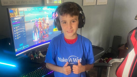 Ian gives a thumbs up in front of his new gaming computer.