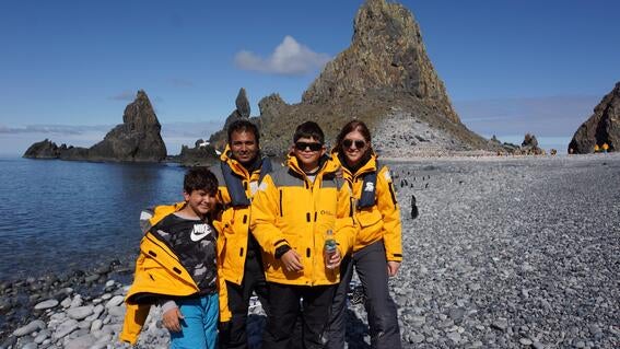 Sachin and family in Antarctica with penguins