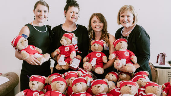 Volunteers at Bubble Ball for Wishes Sake selling Helzberg Diamond stuffed animals bears