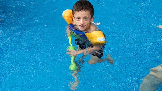 Wish kid Julian in swimming pool