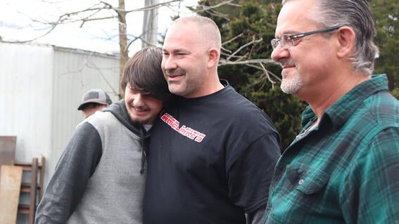 Matthew hugs Mike Ray from 4 Wheel Mike's Auto Body Shop.