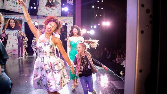 Palmer exits stage right with cast