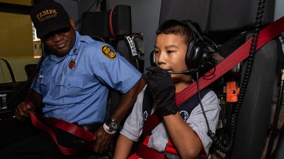 Samuel straps in to the firetruck for a day's work