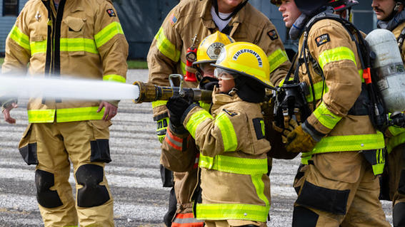 Samuel tests out the fire hose