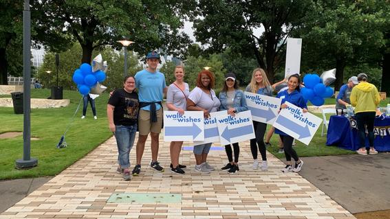 Volunteers hold Walk for Wishes Guide Signs