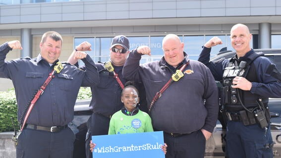Police officers with Wish Kid at event