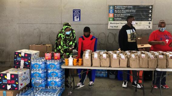 Ja'Bree handing standing with donated food 