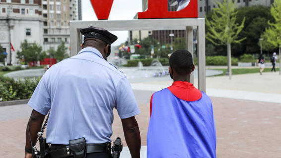 Ja'Bree with a police officer at LOVE park in Philadelphia 
