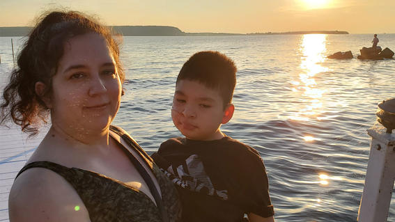 Yahir and his mom enjoy the sunset over the water