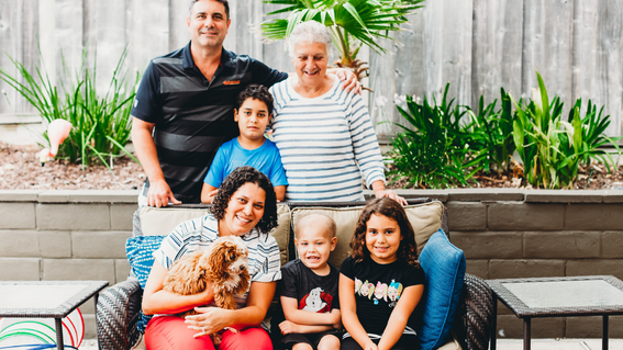 jonny and his family pose with puppy