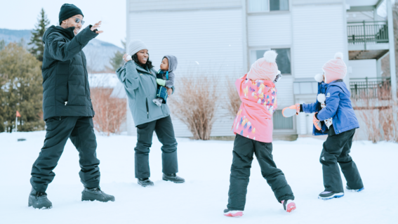 Wish kid Iris and her family play in the snow