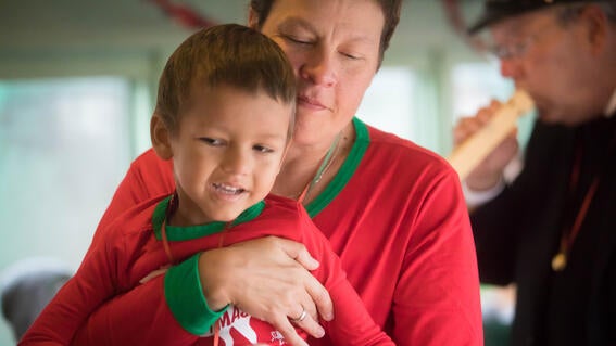 4-year-old Michael is held by his mother on board the train