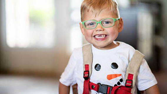 Wish kid Brantley smiling with snowman shirt on.