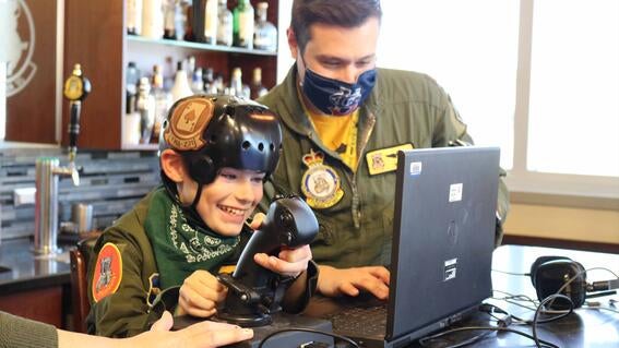 Liam practices his crash landings on the flight simulator. 