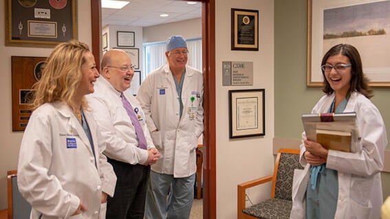 Wish kid Micaela laughing with doctors