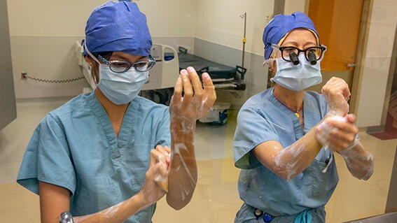 Wish kid Micaela washing hands with a doctor