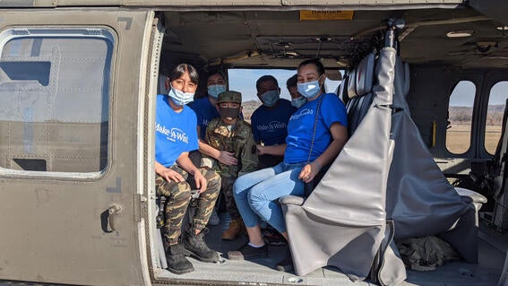 Miguel and family sit in helicopter