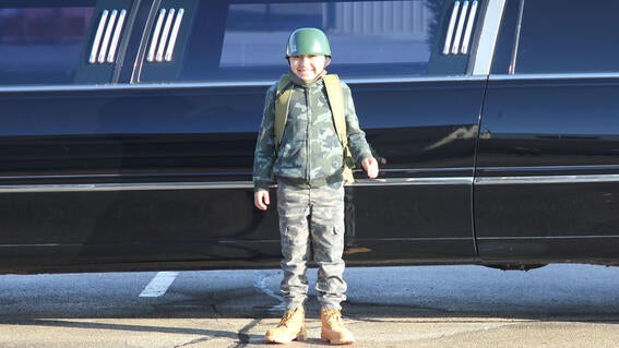 Wish child Miguel near limo