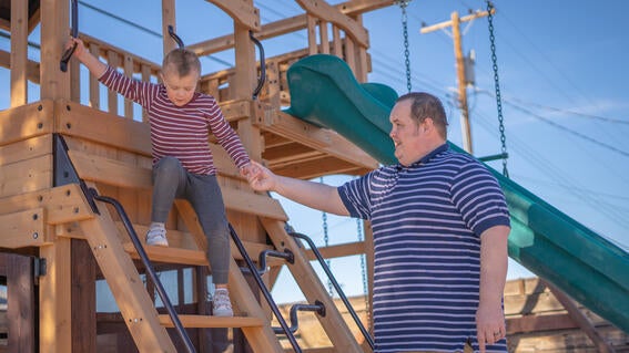 Lucas plays with dad on playground