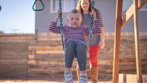 Lucas swings on playground