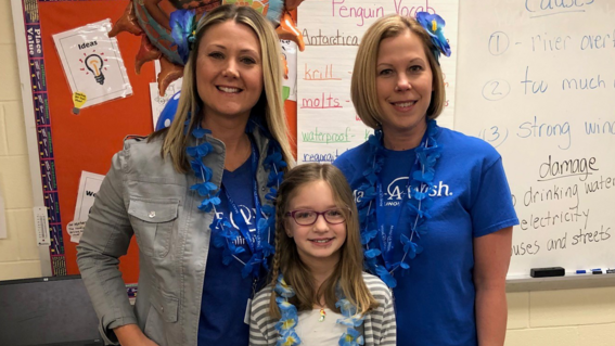 Make-A-Wish volunteers smile with wish child