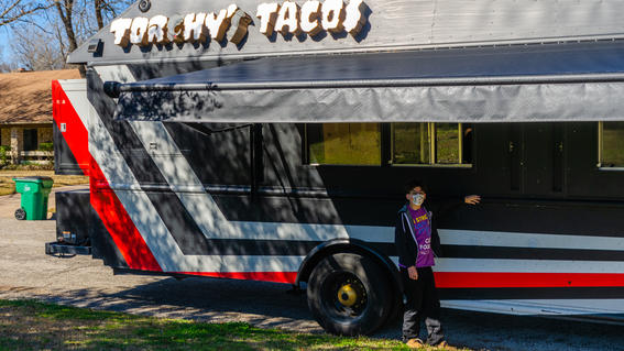 Theoden standing next to Torchy's Tacos Truck