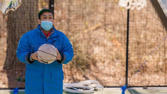 Luke with a basketball looking at the hoop