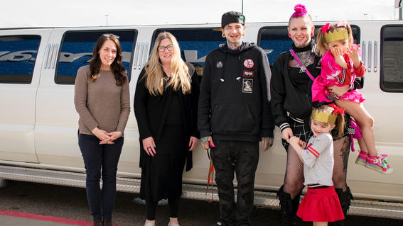 Haukea, her family, and Make-A-Wish volunteers outside the limo