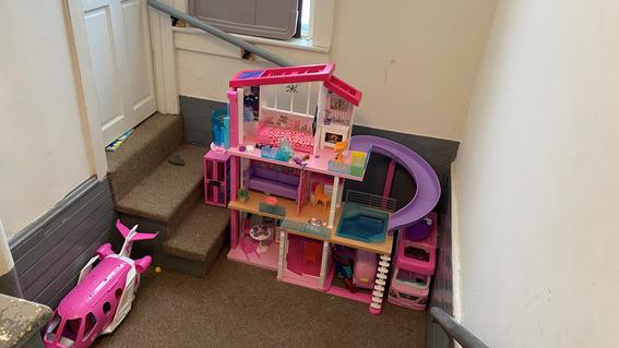 Penelope's Barbie house sitting in her house.