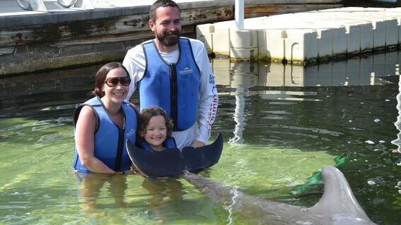 Hannah swims with dolphins