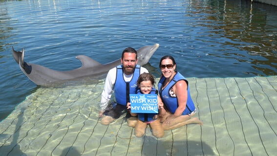 Hannah swims with dolphins