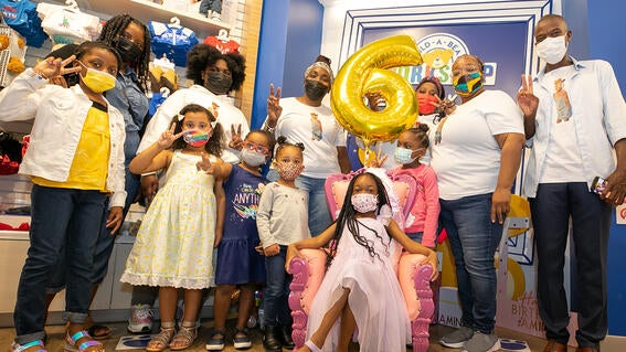 Wish kid Amina celebrates her birthday at Build-A-Bear with friends and family.