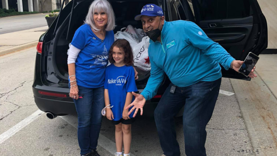 wish granting volunteers smile with wish child Sofia