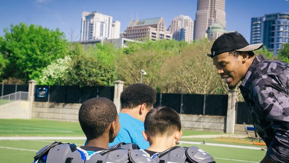 Cam Newton talking to wish kids
