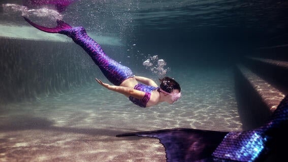 Emma diving in her mermaid tail