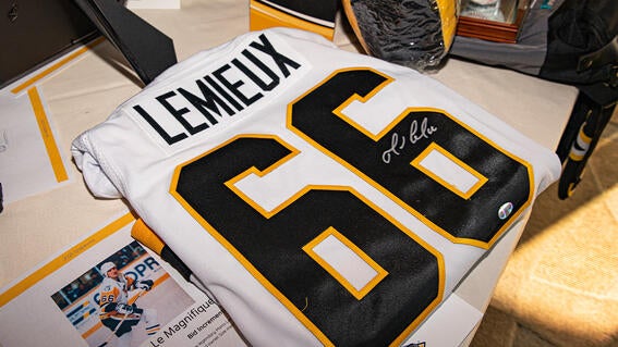 An autographed Mario Lemieux hockey jersey up for auction. 