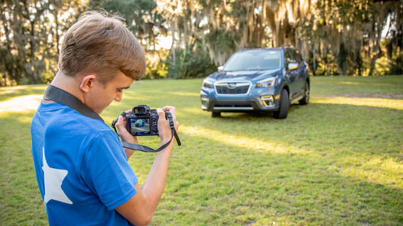 Wish kid Colton using new camera to take pictures of Subaru Forrester