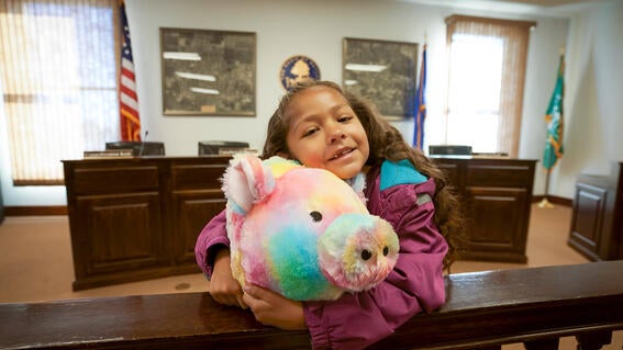AnnieHoldingRainbowPigMayorTedfordsOffice