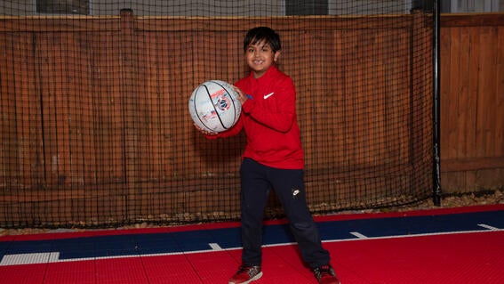 Zain smiles on his new basketball court