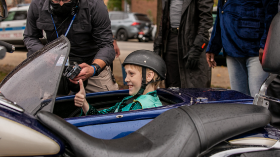 Cyrus rides in a sidecar