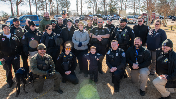 Bennett poses with law enforcement officers and first responders 