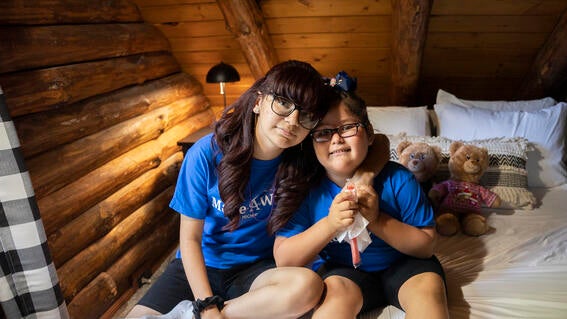 Wish kid Johanna and her sister in their cabin near the beach