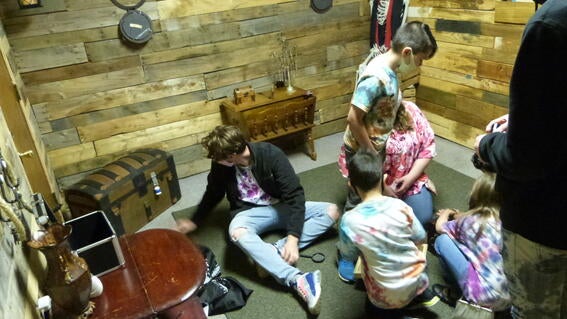 The family sitting on the floor solving a puzzle