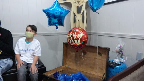 Levi sitting with the open treasure chest revealing his wish