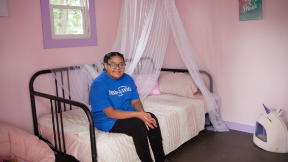 Luz sitting on her new day bed