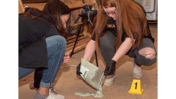 Margaret finding suspect's footprint.